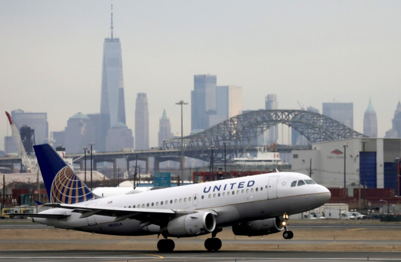   A United Airlines passenger jet takes off with New York City as a backdrop, at Newark Liberty International Airport, New Jersey, US December 6, 2019. (credit: REUTERS/CHRIS HELGREN)