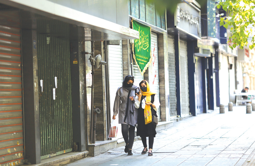 PEDESTRIANS WALK past walk closed shops in Tehran last month. (photo credit: MAJID ASGARIPOUR/WANA/REUTERS)