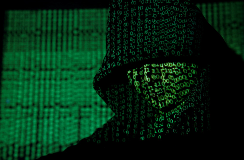 Projection of cyber code on hooded man (llustrative) (credit: REUTERS/KACPER PEMPEL/ILLUSTRATION TPX IMAGES OF THE DAY)