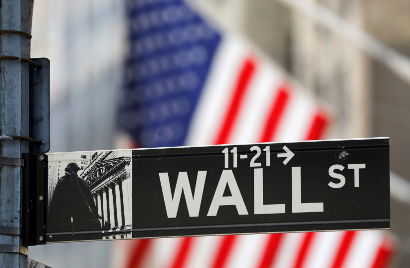  A street sign for Wall Street is seen outside the New York Stock Exchange (NYSE) in New York City, New York, US, July 19, 2021. (credit: REUTERS/ANDREW KELLY/FILE PHOTO)