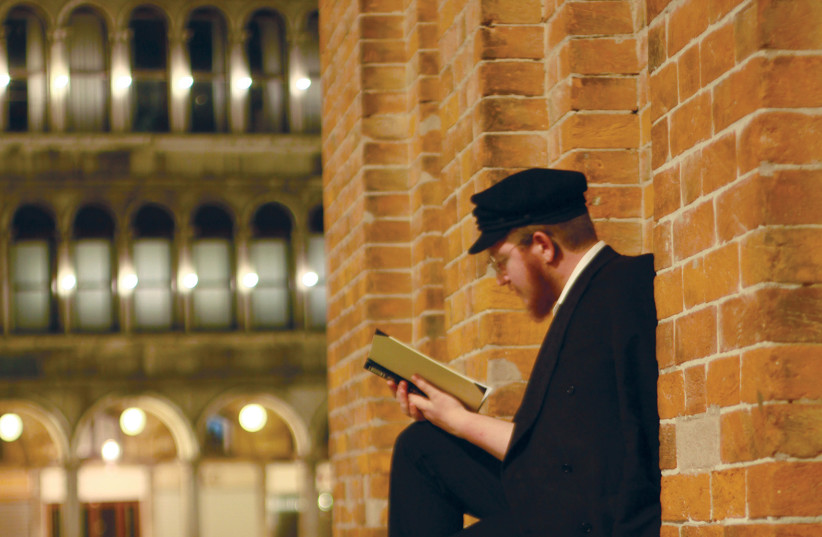 Menachem Forester studying Talmud at the Piazza San Marco in Venice.