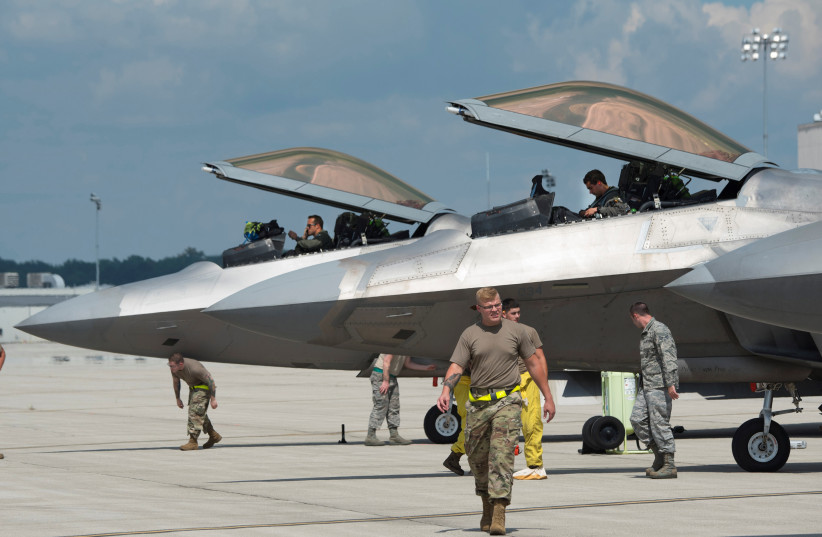  US Air Force pilots and aircraft mechanics of the 325th Fighter Wing secure F-22 Raptor aircraft relocating due to Hurricane Laura, shortly after their arrival at Wright-Patterson Air Force Base, Ohio, US August 23, 2020. (credit: US AIR FORCE/RJ ORIEZ/HANDOUT VIA REUTERS)
