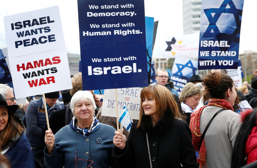  People hold placards during the ''Rally for Equal Rights at the United Nations (Protesting Anti-Israeli Bias)'' in Geneva,  March 18, 2019. (credit: REUTERS/DENIS BALIBOUSE)