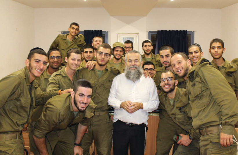  NEVER ALONE. Rabbi Shalom Myers with a few of the many lone soldiers he assists at an IDF base. (credit: Courtesy)