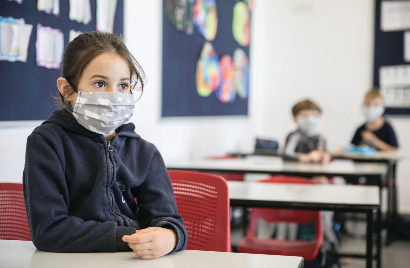  CHILDREN WEAR face masks upon returning to school for the first time since the heartbreak of COVID-19, in May of last year. (photo credit: OLIVIER FITOUSSI/FLASH90)