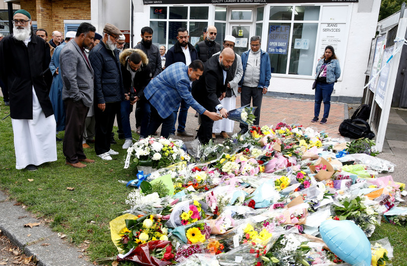 Members of the local Muslim community lay flowers in tribute to British MP David Amess, who was stabbed to death during a meeting with constituents, near the Belfairs Methodist Church, in Leigh-on-Sea, Britain, October 16, 2021.