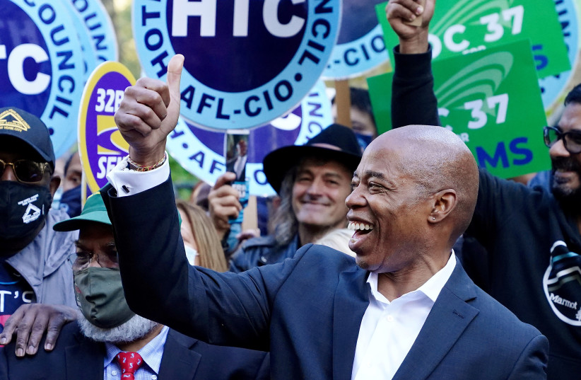 Democratic candidate for New York City Mayor Eric Adams attends a rally at City Hall the day before the election in the Manhattan borough of New York City, New York, U.S., November 1, 2021.  (photo credit: REUTERS/CARLO ALLEGRI)