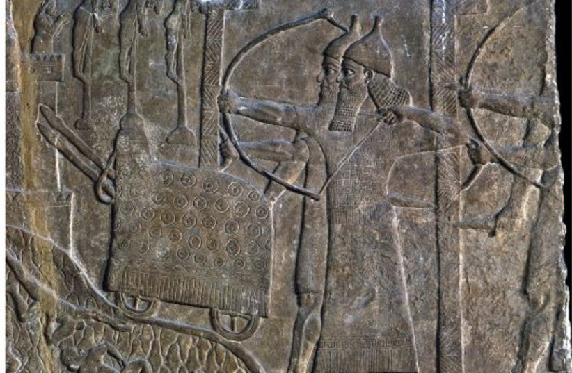  Siege scene with two massive L-shaped shields protecting Assyrian soldiers, in a relief from the palace of Tiglath-Pileser III at Nimrud (credit: Courtesy of the British Museum)