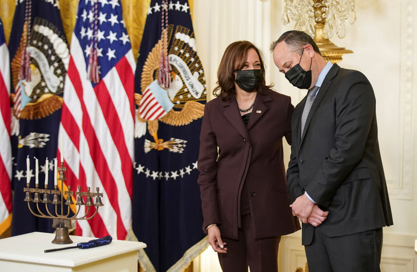 Second gentleman Doug Emhoff, the first Jewish spouse of a president of a vice president, and his wife US Vice President Kamala Harris, stand beside a menorah during a Hanukkah celebration at the White House in Washington, US, December 1, 2021.