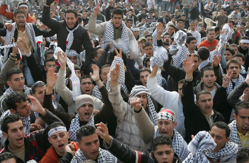 Palestinians take part in a rally to mark the founding of Fatah in 1965, at the Arab American University in the West Bank city of Jenin, January 6, 2008. (credit: REUTERS/MOHAMAD TOROKMAN)