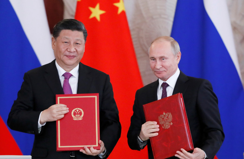  Russian President Vladimir Putin and his Chinese counterpart Xi Jinping pose after signing ceremony in Moscow, Russia, June 5, 2019 (photo credit: REUTERS/EVGENIA NOVOZHENINA)