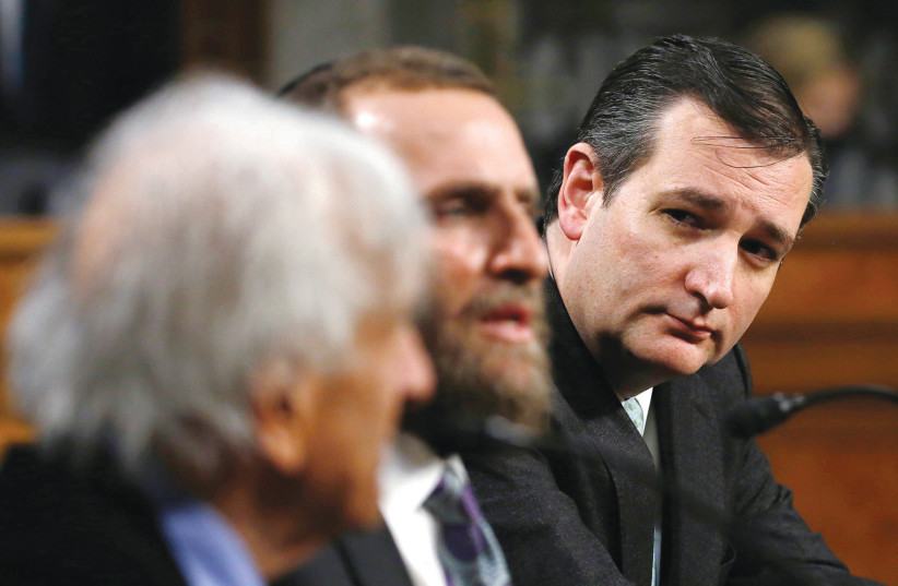 Rabbi Shmuley Boteach, the moderator, is flanked by Nobel Peace laureate Elie Wiesel and US Sen. Ted Cruz at a roundtable discussion on Capitol Hill in 2015, on ‘The Meaning of Never Again: Guarding Against a Nuclear Iran.’ (credit: GARY CAMERON/REUTERS)