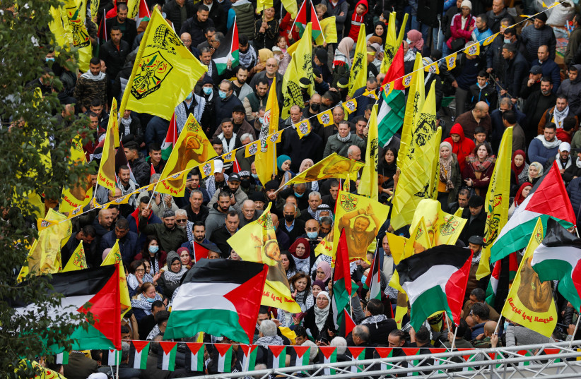  Palestinians attend a rally marking the 57th anniversary of Fatah movement foundation (credit: REUTERS/MOHAMAD TOROKMAN)
