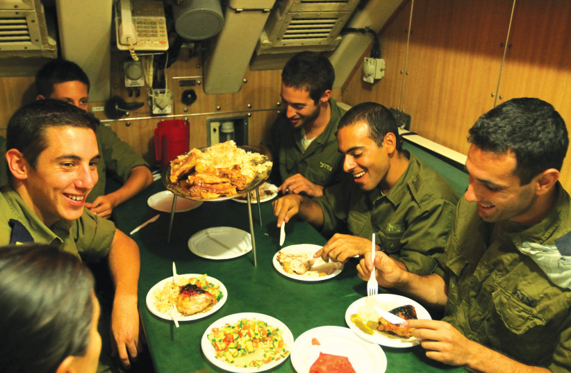  ISRAEL NAVY personnel have a meal aboard a submarine. The public suspects that when the IDF makes decisions on social issues, insufficient importance is given to the well-being of soldiers. (photo credit: MOSHE SHAI/FLASH90)