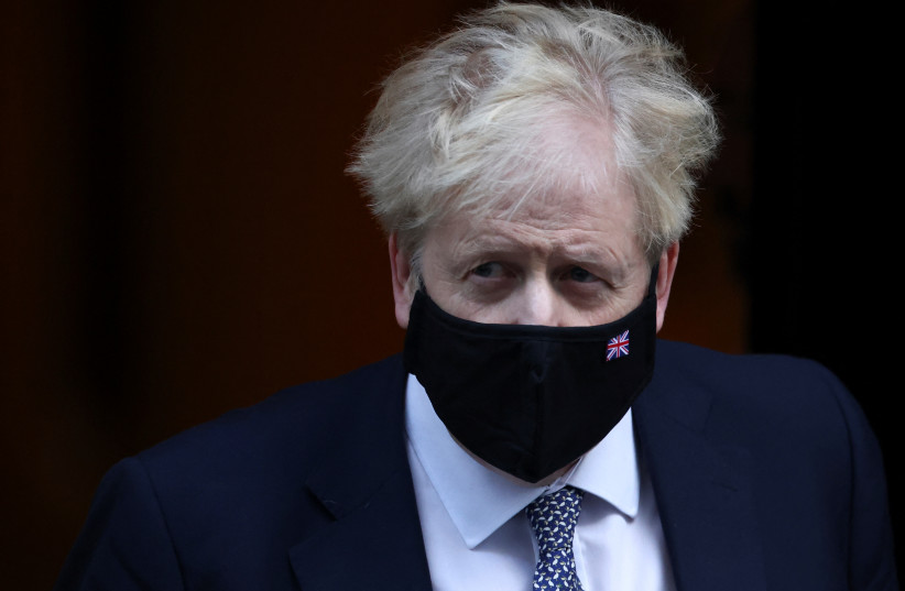 British Prime Minister Boris Johnson walks outside Downing Street in London, Britain, January 12, 2022. (credit: REUTERS/HENRY NICHOLLS)