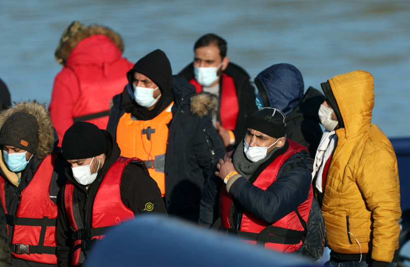 Migrants arrive into the Port of Dover onboard a Border Force vessel after being rescued while crossing the English Channel, in Dover, Britain.