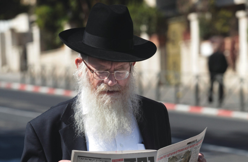  CONVENIENTLY OVERLOOKED: Walder had been a regular columnist for haredi publication ‘Yated Ne’eman’ since 1990. (Pictured: Reading it in Mea She’arim). (photo credit: KOBI GIDEON/FLASH90)