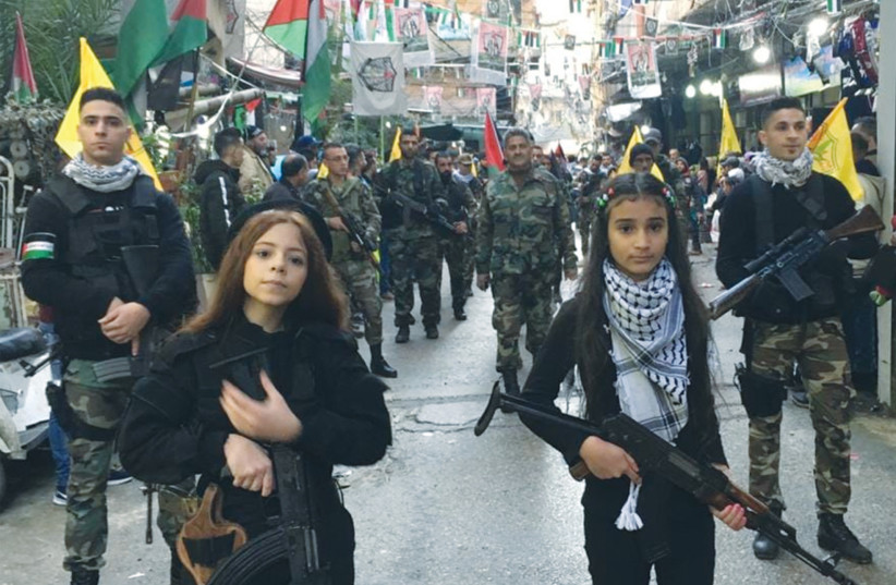  GIRLS WITH automatic rifles lead Fatah’s anniversary parade as seen, according to Palestinian Media Watch, on the official Fatah Facebook page. (credit: PALESTINIAN MEDIA WATCH)