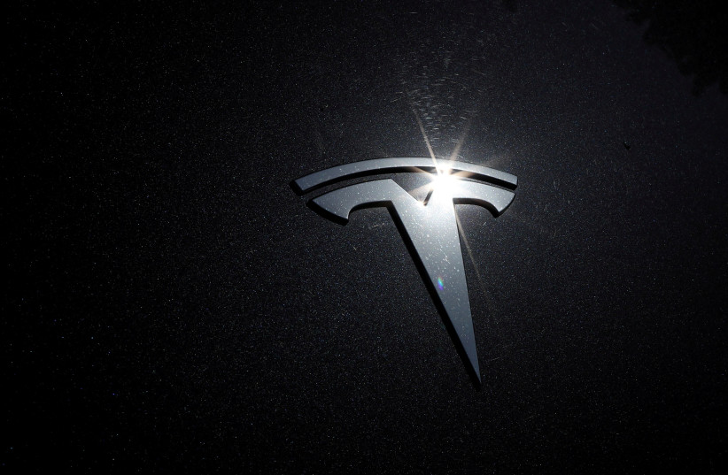  The Tesla logo is seen on a car in Los Angeles, California, US, July 9, 2020.  (credit: REUTERS/LUCY NICHOLSON)