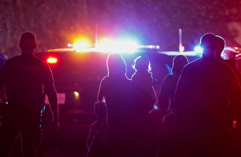 Police officers escort people following a shooting at a church in Sacramento, California, US, February 28, 2022.
