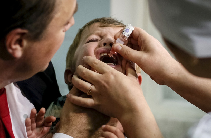  A boy receives polio vaccine drops at a clinic in Kiev, Ukraine, October 21, 2015. (photo credit: GLEB GARANICH/REUTERS)