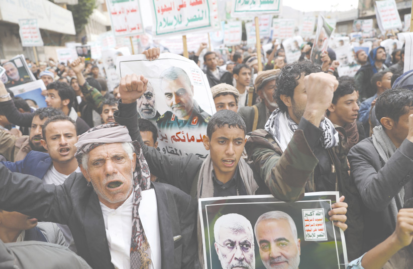  HOUTHI SUPPORTERS rally in Sanaa to denounce the US killing of Iranian military commander Qasem Soleimani and Iraqi militia commander Abu Mahdi al-Muhandis, in 2020. Slogans on signs include: ‘Death to America,’ ‘Death to Israel,’ ‘Curse on the Jews.’ (credit: REUTERS/KHALED ABDULLAH)