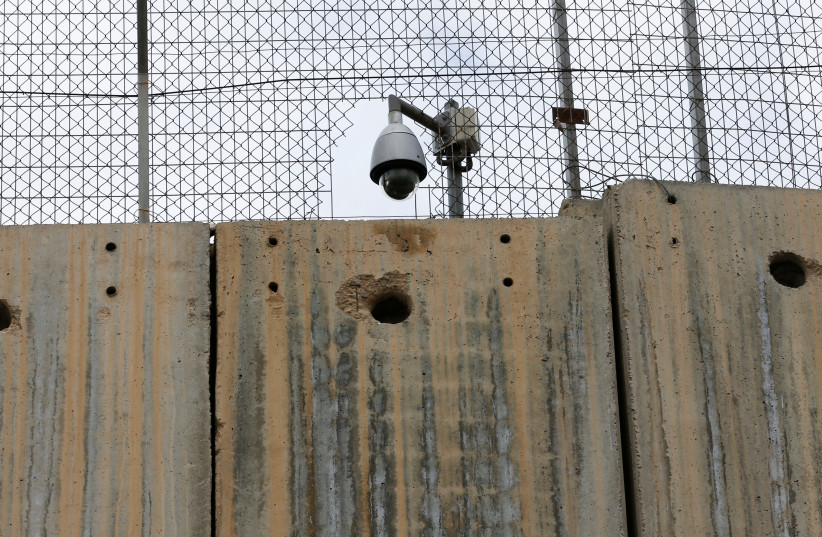  An Israeli security camera is seen on a section of the Israeli barrier in Bethlehem, in the West Bank, February 1, 2022. (photo credit: REUTERS/MUSSA QAWASMA)