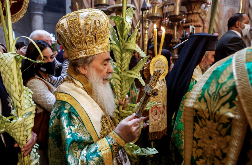  The Greek Orthodox Patriarch of Jerusalem, Theophilos III, leads a procession during Orthodox Palm Sunday, marking the start of Holy Week that ends on Easter Sunday in the Church of the Holy Sepulchre in Jerusalem's Old City April 17, 2022. (credit: AMIR COHEN/REUTERS)