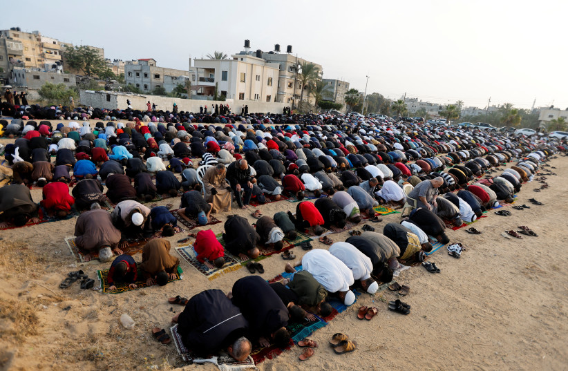  People perform morning prayers to celebrate Eid al-Fitr, marking the end of the holy fasting month of Ramadan, in Khan Younis, in the southern Gaza Strip May 2, 2022 (credit: REUTERS/IBRAHEEM ABU MUSTAFA)