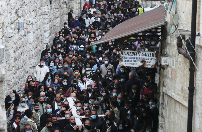  CHRISTIAN WORSHIPERS take part in a Good Friday procession along the Via Dolorosa during Easter Holy Week in Jerusalem’s Old City, in 2021. (credit: AMMAR AWAD/REUTERS)