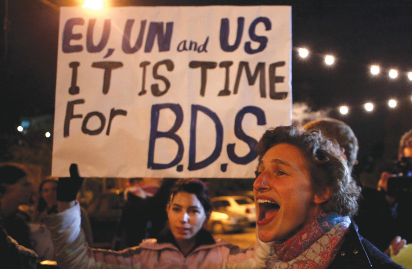  BDS ACTIVISTS in action (photo credit: GALI TIBBON / AFP)