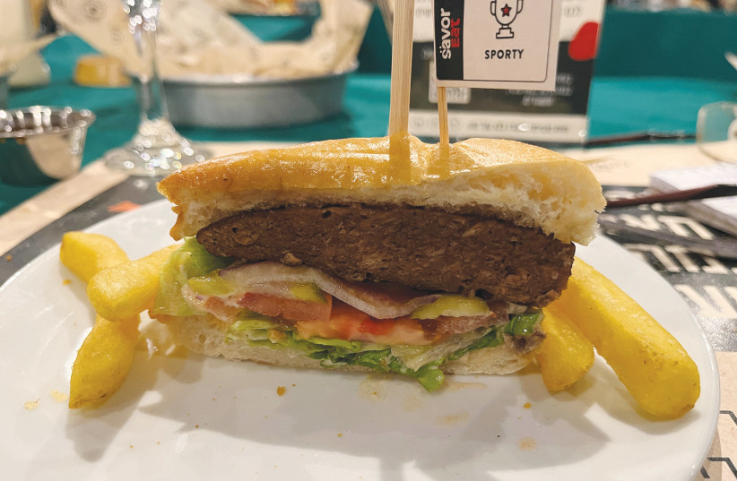  A PLANT-BASED hamburger cooked by a robot developed by Israeli food-tech company SavorEat is served at a restaurant in Herzliya last year. (credit: STEVEN SCHEER/REUTERS)
