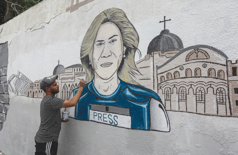  A PALESTINIAN MAN draws a mural of Al Jazeera correspondent Shireen Abu Akleh in Khan Yunis, Gaza Strip. (photo credit: ABED RAHIM KHATIB/FLASH90)