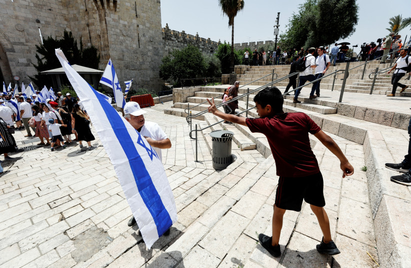  A Palestinian boy and an Israeli man argue near Damascus gate to Jerusalem's Old City, on Jerusalem Day, May 29, 2022. (credit: AMMAR AWAD/REUTERS)