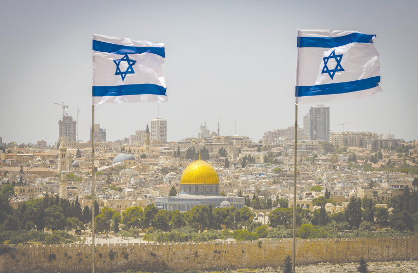  ISRAELI FLAGS flap in the wind on the Mount of Olives, overlooking the Dome of the Rock and Temple Mount. (credit: OLIVER FITOUSSI/FLASH90)