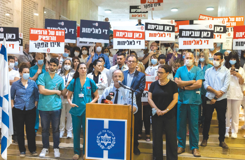 MEDICAL STAFF at Hadassah-Mount Scopus Hospital in Jerusalem assemble and hold placards, declaring a strike and protesting violence against hospital personnel, May 2022. (credit: OLIVIER FITOUSSI/FLASH90)