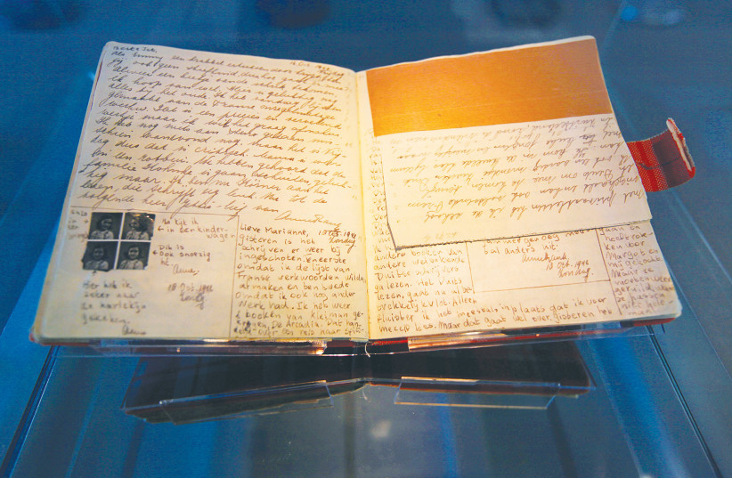  ANNE FRANK’S diary is on display at the Anne Frank House in Amsterdam. Anne told a friend that the moment she learned she no longer had a family she interpreted this as the end of the world.  (photo credit: REUTERS/CRIS TOALA OLIVARES)