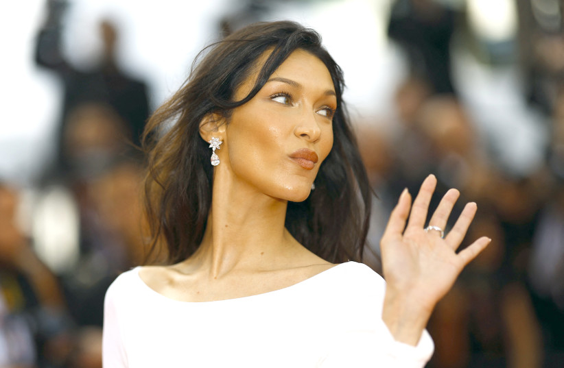  BELLA HADID poses at the Cannes Film Festival last month. To see a company like Swarovski, with a horrific Nazi past, stepping in to fund, empower, and elevate her felt like a kick to the knees, says the writer (credit: REUTERS/STEPHANE MAHE)