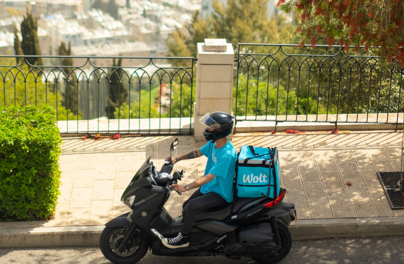  A Wolt courier scooting toward a hungry Haifa resident. (photo credit: Wolt Israel PR)