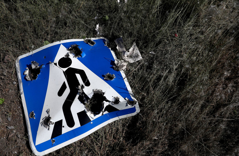  A road sign damaged by cluster munition is seen following a military strike, amid Russia's attack on Ukraine, on the outskirts of Kharkiv, Ukraine June 10, 2022.  (credit: REUTERS/IVAN ALVARADO)