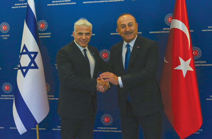  TURKISH FOREIGN MINISTER Mevlut Cavusoglu meets his Israeli counterpart, Yair Lapid (before Lapid became premier), in Ankara, last month. Just ahead of Lapid’s visit, Mossad and its local counterpart in Turkey thwarted three Iranian attacks targeting Israeli civilians, including a former ambassador (credit: REUTERS)