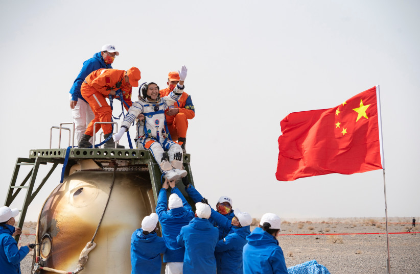  Rescue workers carry Chinese astronaut Zhai Zhigang out of a return capsule after astronauts return to earth following the Shenzhou-13 manned space mission (credit: CHINA DAILY VIA REUTERS)