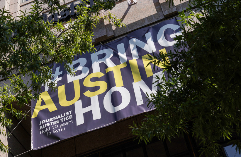  A #BringAustinHome" banner, honoring freelance journalist Austin Tice who was abducted in Syria in 2012, hangs outside of The Washington Post headquarters in Washington, DC, US, Aug. 9, 2022.  (photo credit: REUTERS/SARAH SILBIGER)