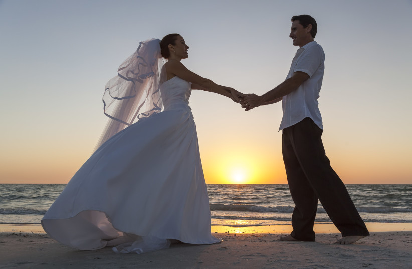  Bride & Groom Married Couple at Sunset Beach Wedding (credit: INGIMAGE)