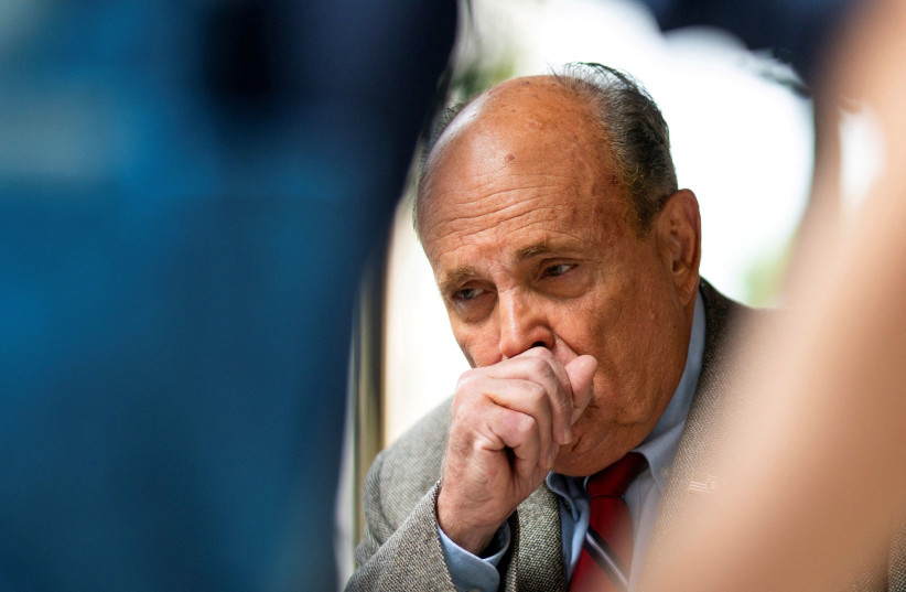  Former New York City Mayor Rudy Giuliani coughs as he speaks to media about the US evacuation of Afghanistan outside his apartment building in New York City, US, August 20, 2021. (photo credit: REUTERS/EDUARDO MUNOZ)