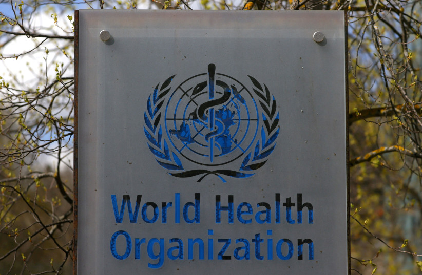 A logo is pictured outside a building of the World Health Organization (WHO) during an executive board meeting on update on the coronavirus disease (COVID-19) outbreak, in Geneva, Switzerland, April 6, 2021. (credit: REUTERS/DENIS BALIBOUSE/FILE PHOTO)