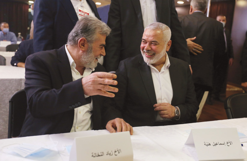  ISMAIL HANIYEH of Hamas (right) and Islamic Jihad leader Ziyad al-Nakhalah attend a Palestinian factions’ meeting in Beirut, 2020. (credit: AZIZ TAHER/REUTERS)