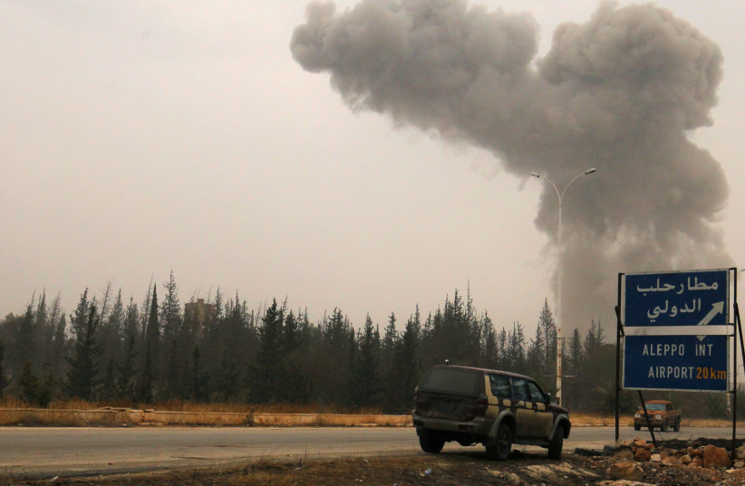  Smoke rises from shelling on the road to Aleppo international airport. (credit: REUTERS/Ammar Abdullah)