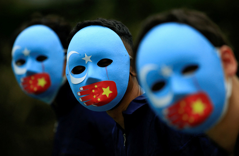  : Activists take part in a protest against China's treatment towards the ethnic Uyghur people and calling for a boycott of the 2022 Winter Olympics in Beijing, at a park Jakarta, Indonesia, January 4, 2022. (credit: REUTERS/WILLY KURNIAWAN/FILE PHOTO)