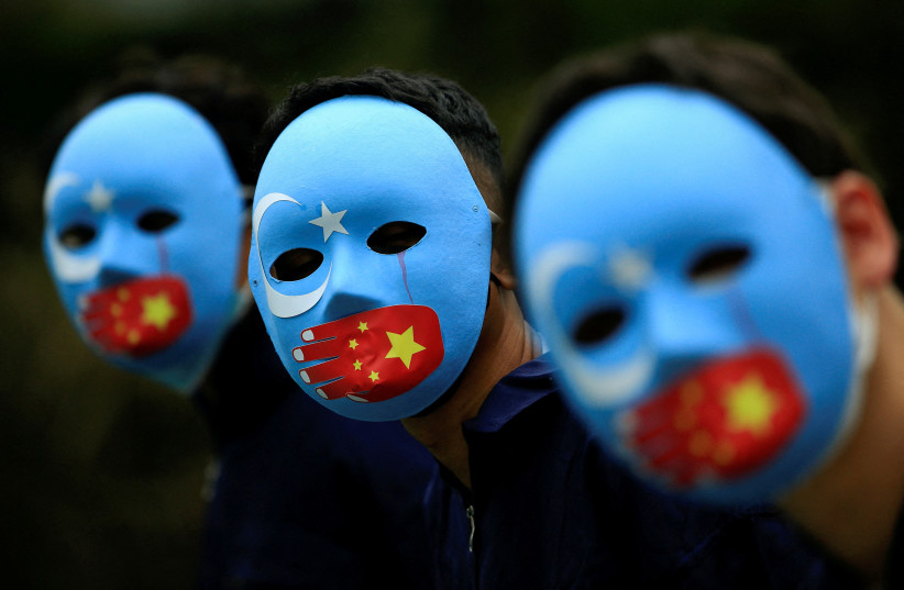 : Activists take part in a protest against China's treatment towards the ethnic Uyghur people and calling for a boycott of the 2022 Winter Olympics in Beijing, at a park Jakarta, Indonesia, January 4, 2022.